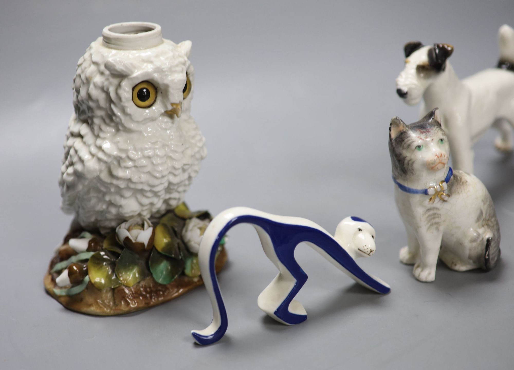 A Victorian porcelain owl oil lamp base, lacking mount, an Austrian porcelain terrier and two other ceramic animals, tallest 16.5cm